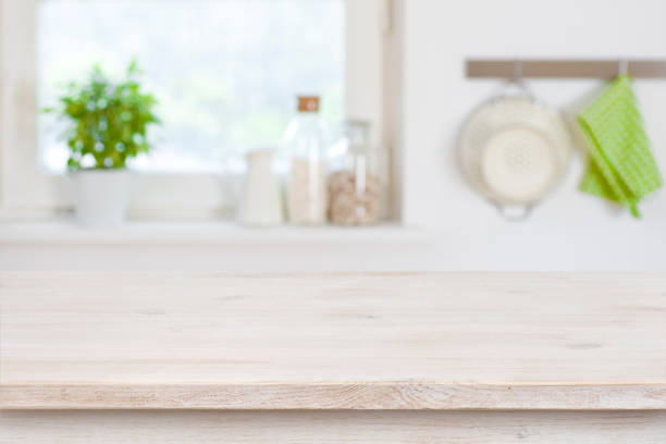 istock Wooden table top in front of blurred kitchen interior background 956044970