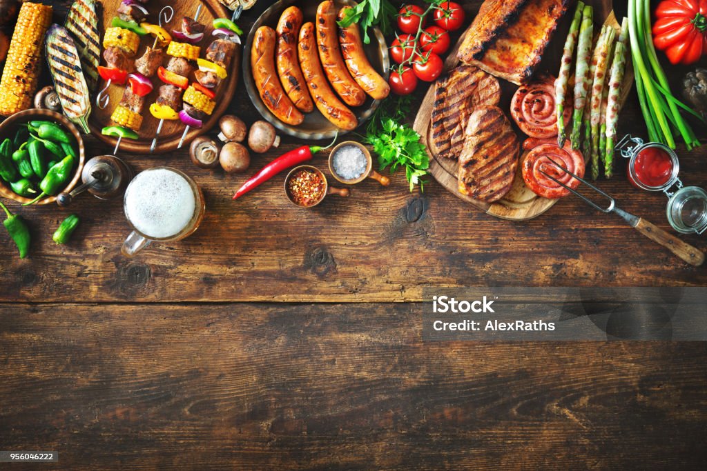 Grilled meat and vegetables on rustic wooden table Grilled meat and vegetables on rustic wooden table. Barbecue menu Barbecue - Meal Stock Photo