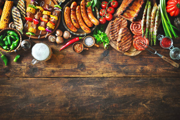 grilled meat and vegetables on rustic wooden table - sausage bratwurst barbecue grill barbecue imagens e fotografias de stock