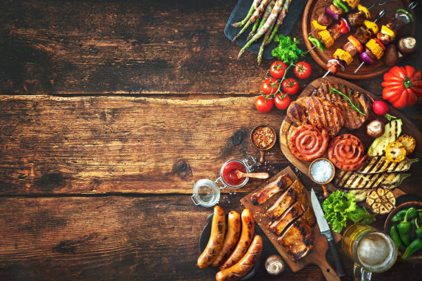 istock Grilled meat and vegetables on rustic wooden table 956046224