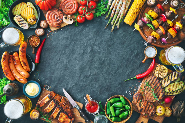 istock Grilled meat and vegetables on rustic stone plate 956046244
