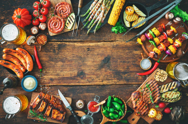 istock Grilled meat and vegetables on rustic wooden table 956046246