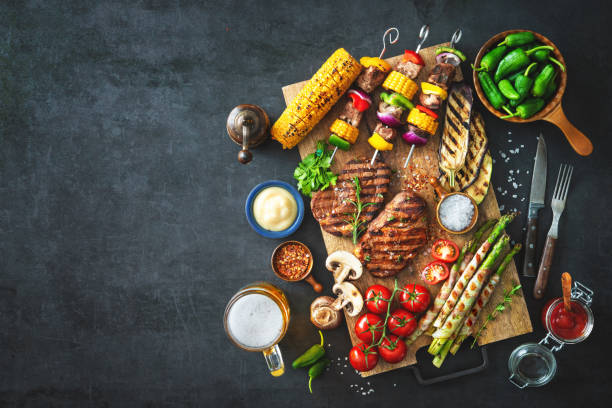 Grilled meat and vegetables on rustic stone plate
