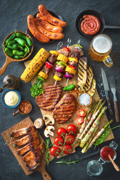 istock Grilled meat and vegetables on rustic stone plate 956046264