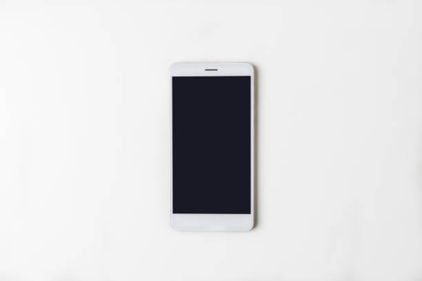istock Top view of office workplace. White desk with copy space. Flat lay view on table with phone in centre. Creative designer concept. 956046368