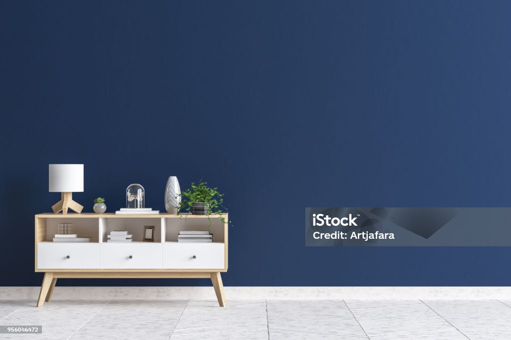 Chest of drawers in living room interior, dark blue wall mock up background Chest of drawers in living room interior, dark blue wall mock up background, 3D render Blue Stock Photo