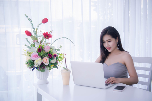 Smart girl's working on notebook , Workingwoman using laptop in the room