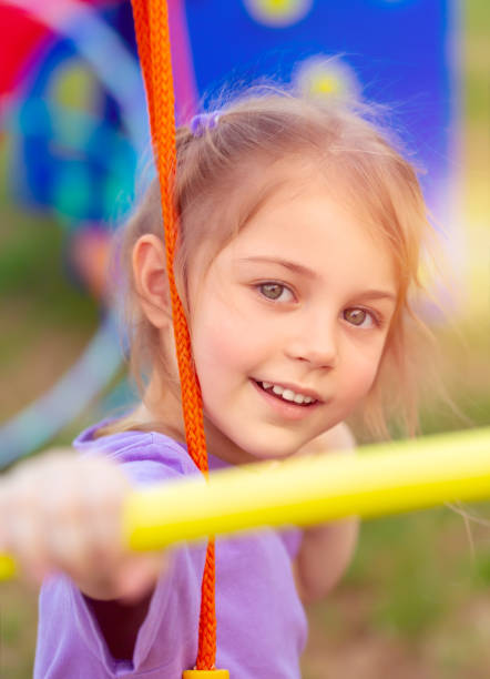 istock Cute little girl on the swing 956050948