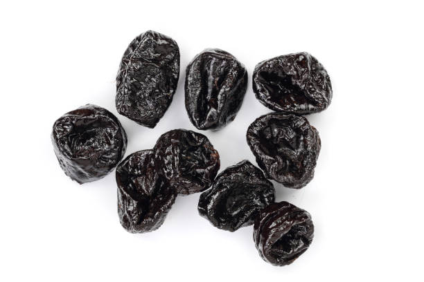 istock Dried plum - prunes isolated on a white background. Top view. Flat lay 956051038