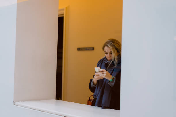 istock Blonde girl writing message with phone 956052336