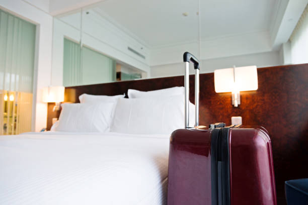 istock Suitcase in hotel room 956052870