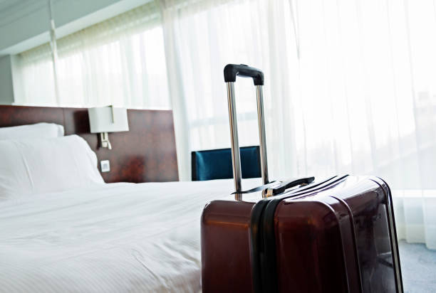 istock Suitcase in hotel room 956052898