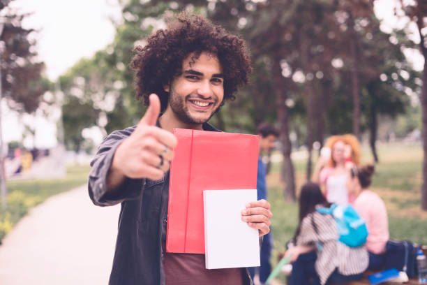 istock Young man showing OK sign with his thumb up 956053098