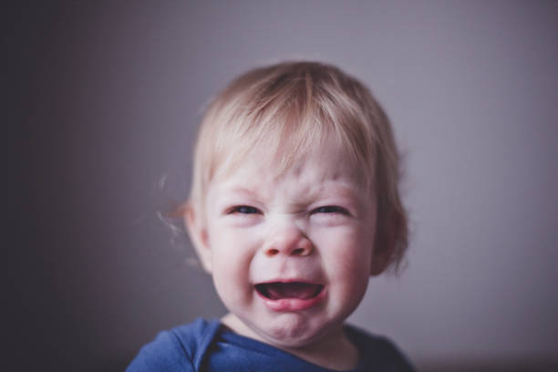 istock Cute a small child bitterly cries. Close up. 956055962