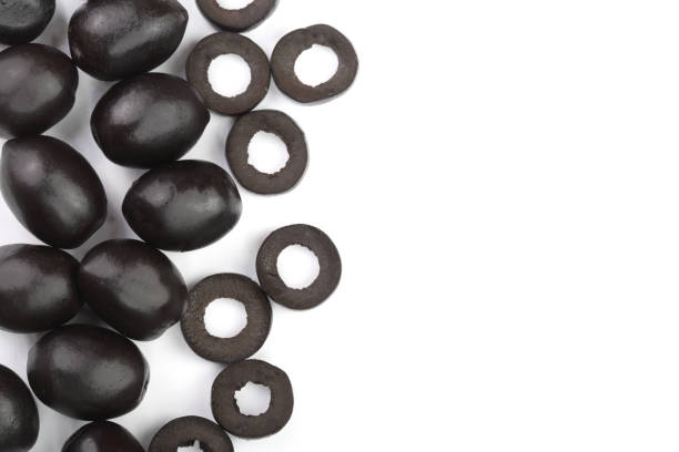 istock whole and sliced black olives isolated on white background with copy space for your text. Top view. Flat lay pattern 956056172