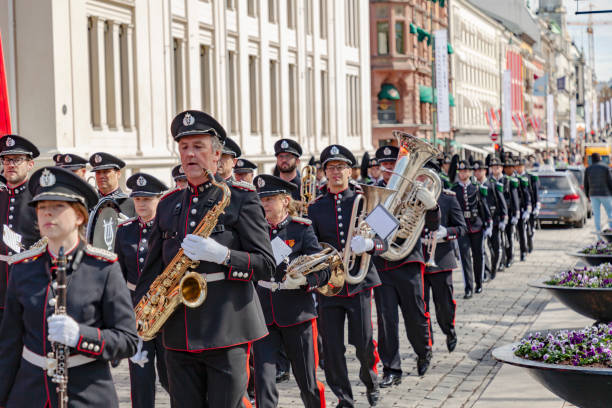 His Majesty The King's guard  and brass band marching on the main street of Oslo, Karl Johan, towards the Royal Castle.