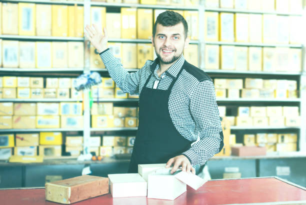 istock Man seller showing diverse assortment 956060712