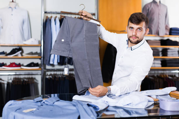istock Positive man choise new pair of pants 956060810