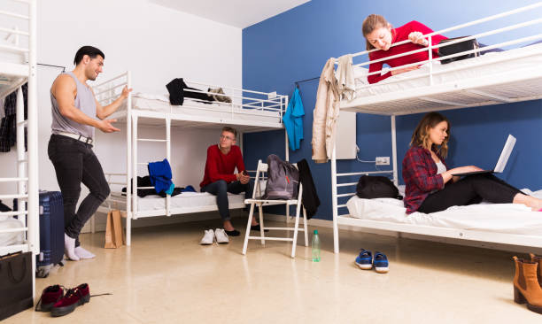 Travelers communicating in hostel bedroom