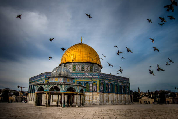 Dome of the Rock with birds flying in Jerusalem A dramatic shot of the Dome of the Rock, Jerusalem al aksa mosque stock pictures, royalty-free photos & images