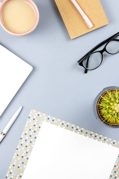 istock Flat lay home office desk. Female workspace with planner, eyeglasses, tea mug, diary, plant. Copy space 956067636