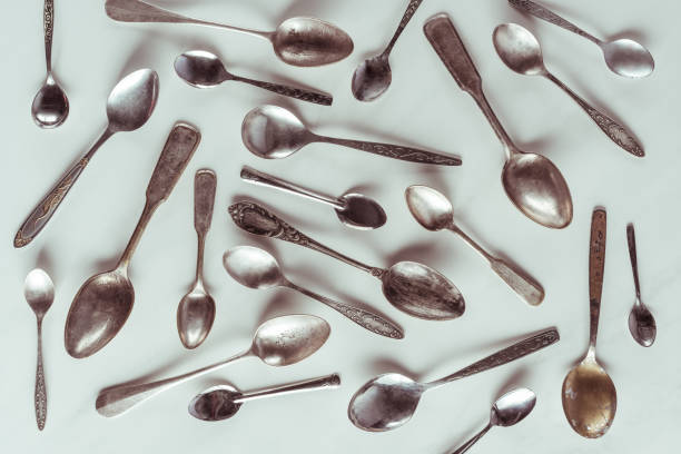istock Vintage metal spoons on white background 956075228
