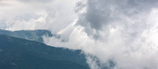 istock Mountains surrounded by clouds. Close up 956075630