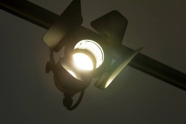 istock cinematic lamp searchlight with curtains suspended on a beam brightly shines 956075780