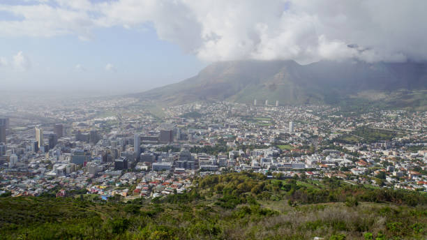 Cape Town in South Africa View to the sea of houses of Cape Town in South Africa, dense clouds around the Table Mountain table mountain and the tablecloth stock pictures, royalty-free photos & images