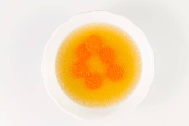 istock Clear beef broth with carrot slices. bone broth. Bouillon in white bowl. 956076630