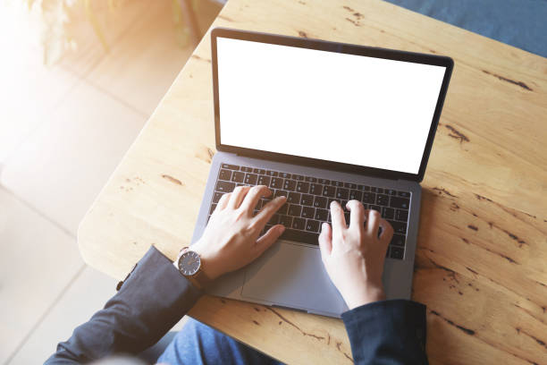 istock Business women using laptop with blank screen at table in the office. 956076730