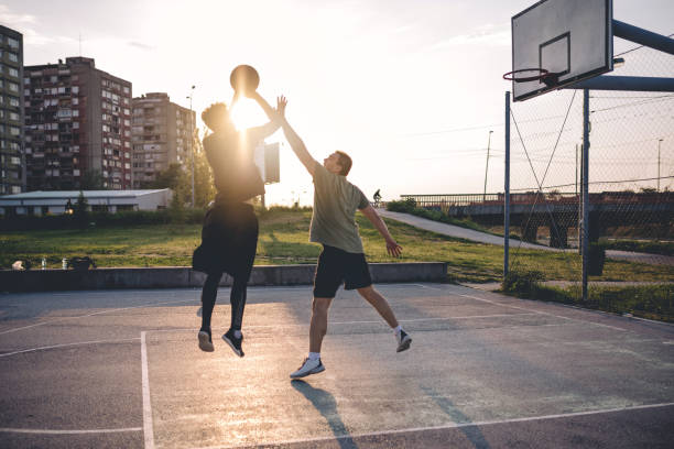 istock Playing basketball on an outdoors terrain 956077076