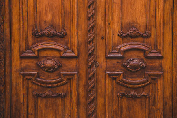 istock old wooden brown doors in building in Rome, Italy 956077752