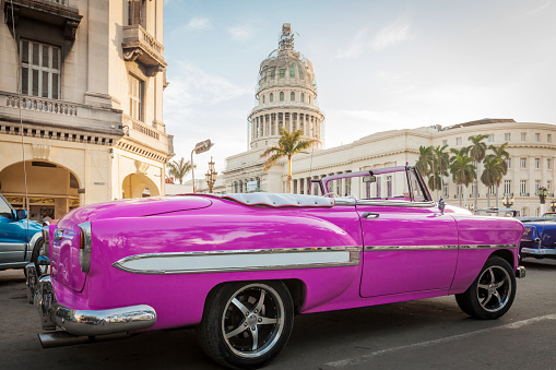 Pink convertible parked near Parque Central and the Capitol in Havana.