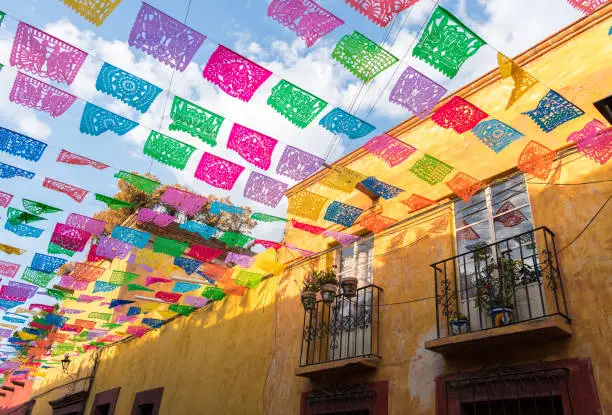 Photo of Colorful paper flags over street