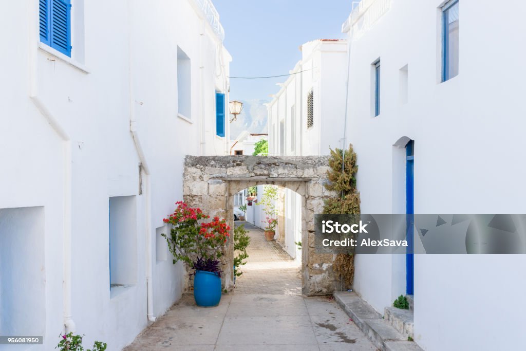 Alley between beautiful white and blue houses Alley between beautiful white and blue houses in Kyrenia, Northern Cyprus Republic Of Cyprus Stock Photo
