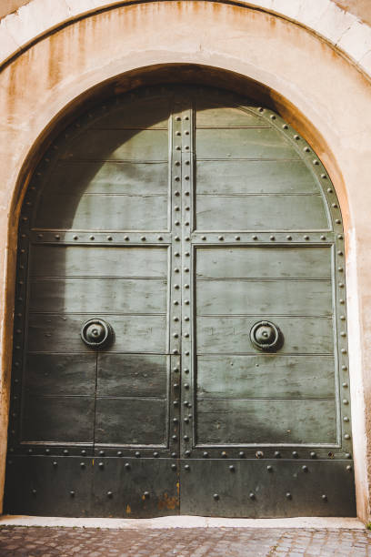 istock old green doors in building in Rome, Italy 956085088