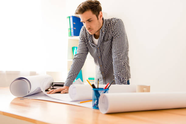 istock Portrait of a handsome guy in his office working on project 956085854