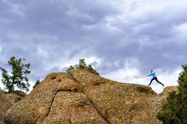 istock Woman Hiking and Jumping Red Rock Canyon Feature 956086082