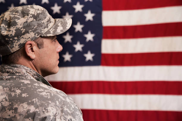 istock USA armed forces military man with American flag. 956086584
