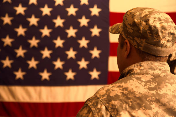 istock USA armed forces military man with American flag. 956086618