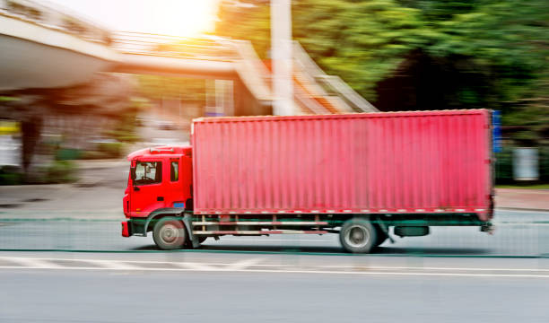 istock Red freight truck driving on the road 956087278