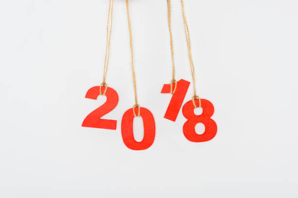 istock close up view of 2018 year sign hanging on strings isolated on white 956097808