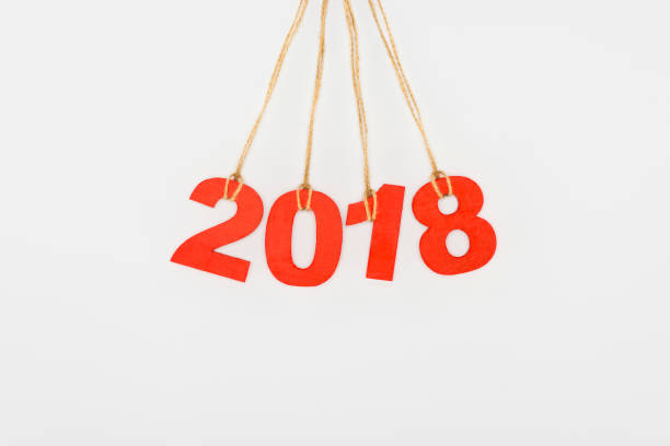 istock close up view of 2018 year sign hanging on strings isolated on white 956098876