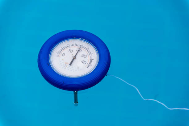 istock Pool thermometer is tied with rope on blue water 956099144