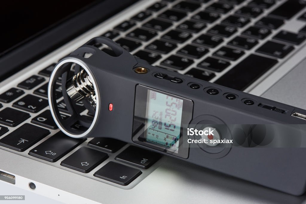 Voice recorder on a laptop Voice recorder on a laptops keyboard close up. blogging concept. Recorder - Musical Instrument Stock Photo