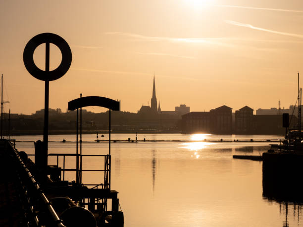 istock Sunrise in Preston Docks with cityscape 956099218