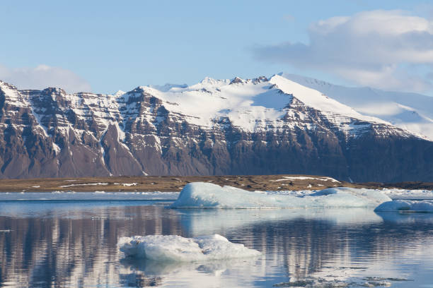 istock Jokulsarlon lagoon with black volcano mountain background 956099266