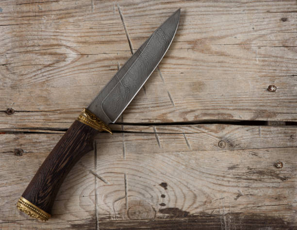 istock hunting knife on a wooden background 956099354