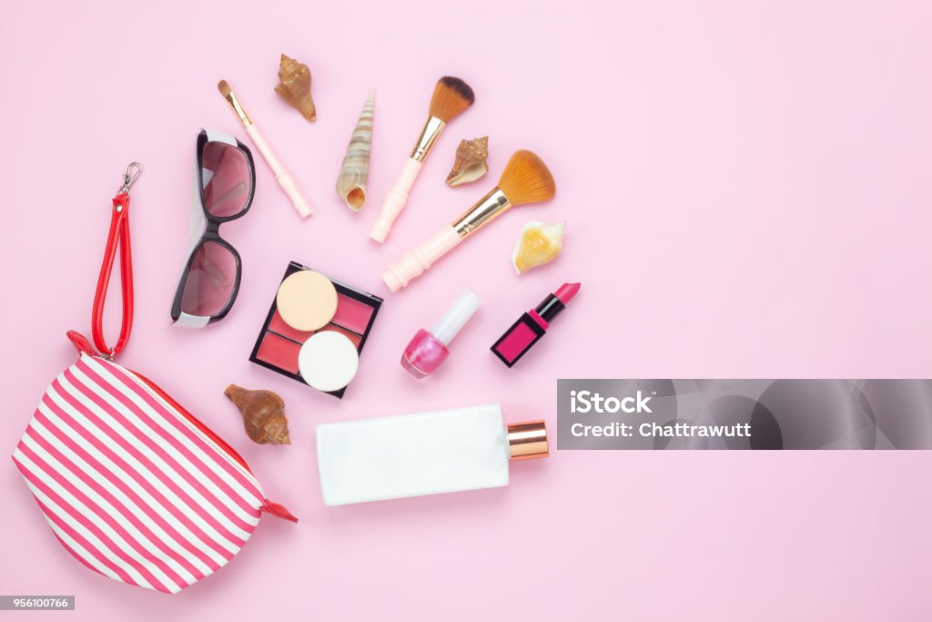 Table top view women fashion & beauty for travel summer holiday background concept.Flat lay accessories objects sun glasses & sun block body lotion on modern rustic pink paper wallpaper and copy space Make-Up Stock Photo